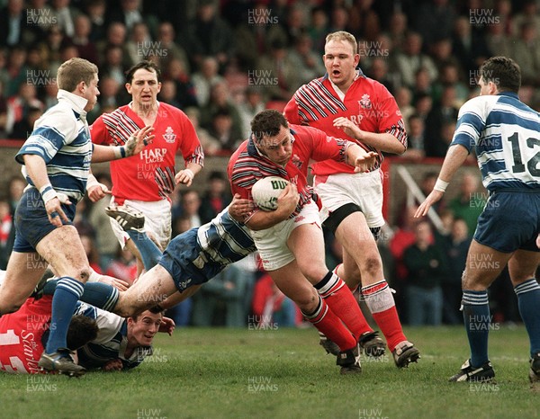 080495 - Llanelli v Bridgend - Robin Mcbryde of Llanelli is tackled by Matthew Lewis