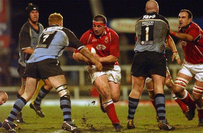 040203 - Llanelli v Cardiff - Welsh Premiership - Llanelli's John Davies runs into Martyn Williams