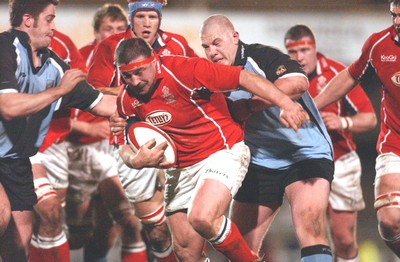 040203 - Llanelli v Cardiff - Welsh Premiership - Llanelli's John Davies escapes John Yapp (left)