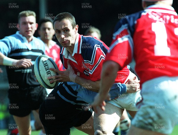 130497 - Llanelli v Cardiff - Wayne Proctor looks for support as he's tackled by Mike Hall