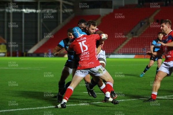 181022 - Llanelli v Cardiff - Indigo Group Premiership - James Beal of Cardiff is tackled by Llew Smith(15) and Ben Raivalitia of Llanelli 