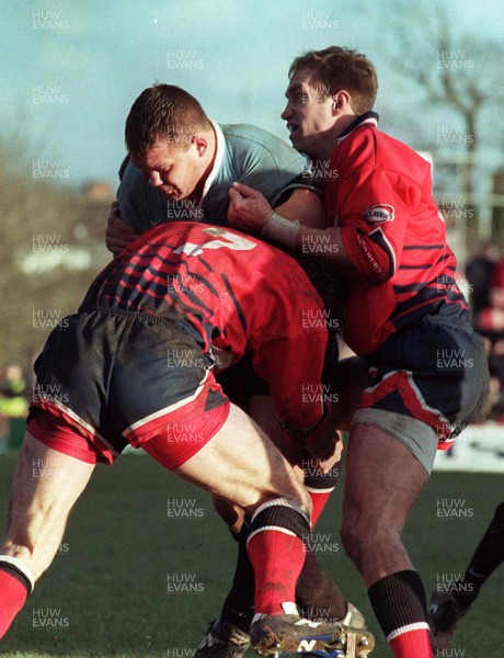 271297 - Llanelli v Cardiff -  Spencer John is tackled by David Hodge and Iwan Jones