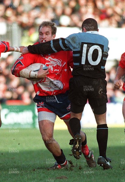 271297 - Llanelli v Cardiff -  David Hodges is tackled by Paul Williams