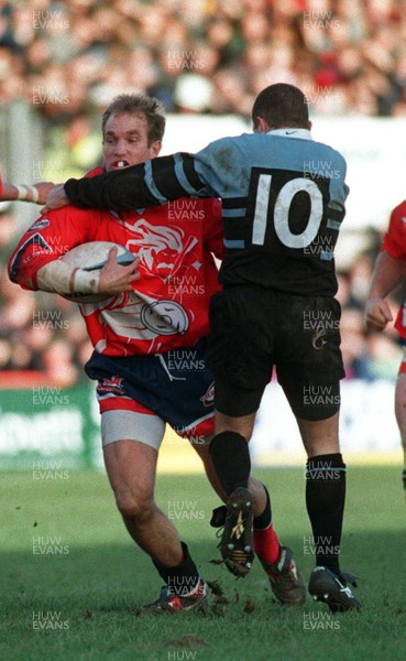 271297 - Llanelli v Cardiff -  David Hodges is tackled by Paul Williams