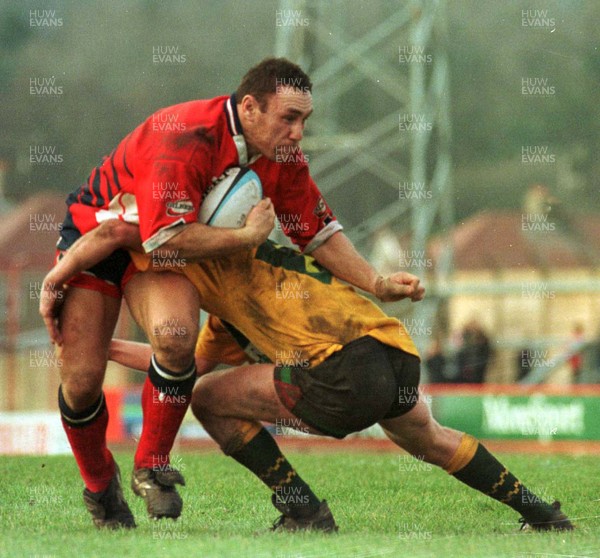 201297 - Llanelli v Dunvant - Robin Mcbryde is tackled by Stuart Jenkins