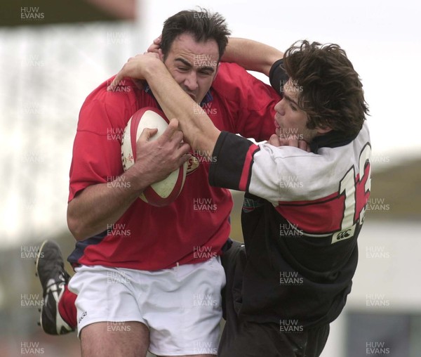 210401 - Llanelli v Edinburgh Reivers - Welsh-Scottish League - Llanelli's Chris Wyatt is tackled by Marcus Di Rollo