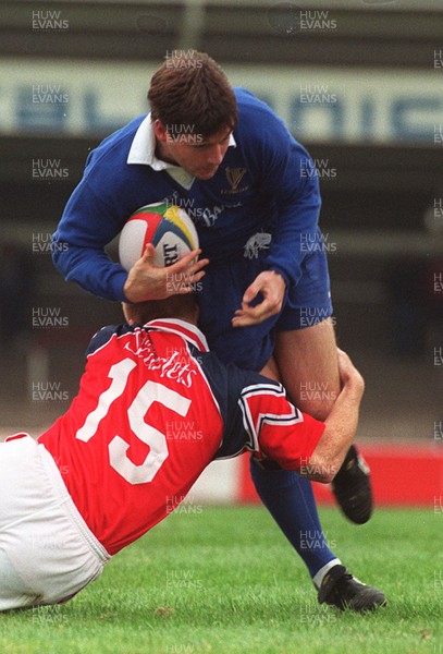 121096 - Llanelli v Leinster - Alain Rolland of Leinster is tackled by Garan Evans