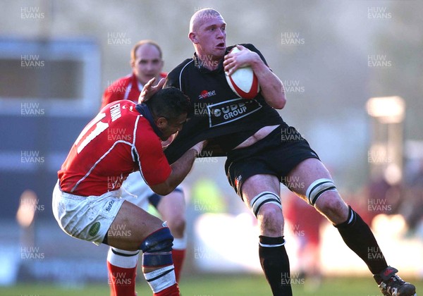 050403 - Llanelli v Neath - Principality Cup Quarter Final - Salesi Finau gets hold of Neath's Lyndon Bateman