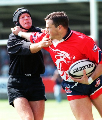 160897 - Llanelli v Neath - Matthew Wintle of Llanelli holds off Ian Calder