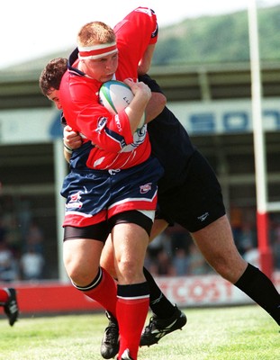 160897 - Llanelli v Neath - Steve Ford of Llanelli is tackled by Thierry Devergie