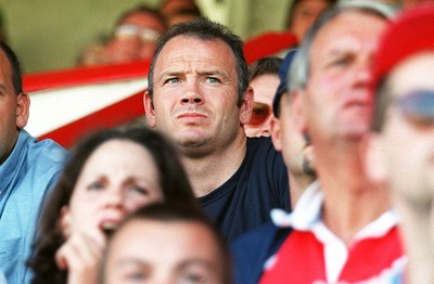 160897 - Llanelli v Neath - Ieuan Evans who signed for Bath yesterday watches the game from the stand