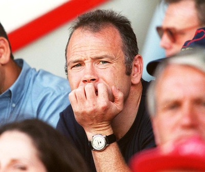 160897 - Llanelli v Neath - Ieuan Evans who signed for Bath yesterday watches the game from the stand