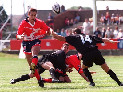 160897 - Llanelli v Neath - Wayne Procter of Llanelli kicks past Paul Williams