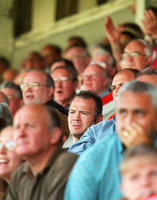 160897 - Llanelli v Neath - Ieuan Evans who signed for Bath yesterday watches the game from the stand