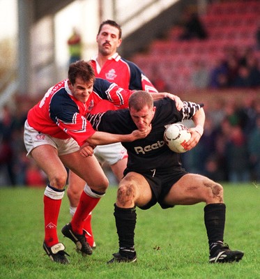 251195 - Llanelli v Neath - Leigh Davies of Neath is tackled by Neil Boobyer