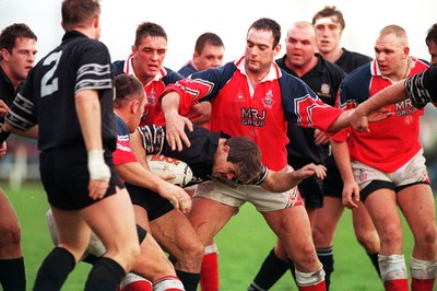 251195 - Llanelli v Neath - Chris Bridges of Neath is tackled by Julian Williams