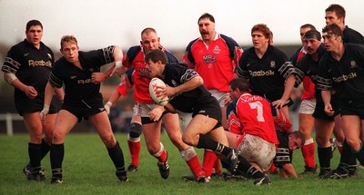 251195 - Llanelli v Neath - Chris Bridges of Neath attempts to run around the pack