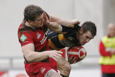 03.04.10 Llanelli RFC v Newport RFC - Principality Premiership - Newport's Mike Poole tries to hand off Llanelli's Scott Williams. 