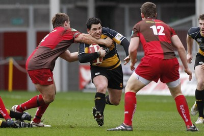 03.04.10 Llanelli RFC v Newport RFC - Principality Premiership - Newport's Scott Williams is collared by Llanelli's Rhys Lawrence. 