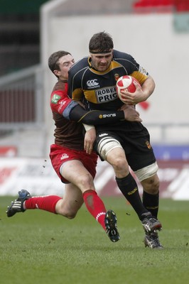 03.04.10 Llanelli RFC v Newport RFC - Principality Premiership - Newport's Adam Brown is tackled by Llanelli's Steve Shingler. 