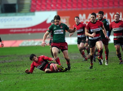 04.02.12. Llanelli RFC v Pontypool RFC, Principality Premiership..Pontypool's Tom Hanccock (left) and Llanelli's Nic Reynolds chase down the ball..