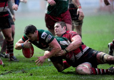 04.02.12. Llanelli RFC v Pontypool RFC, Principality Premiership..Llanelli's Joe Heatley scores as Pontypool's Calwyn Morgan brings him down..