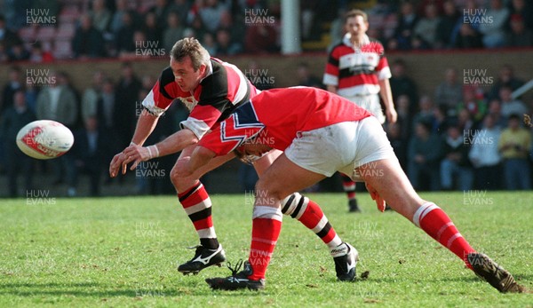 220397 - Llanelli v Pontypool - David Bishop of Pontypool is tackled by Hywel Jenkins