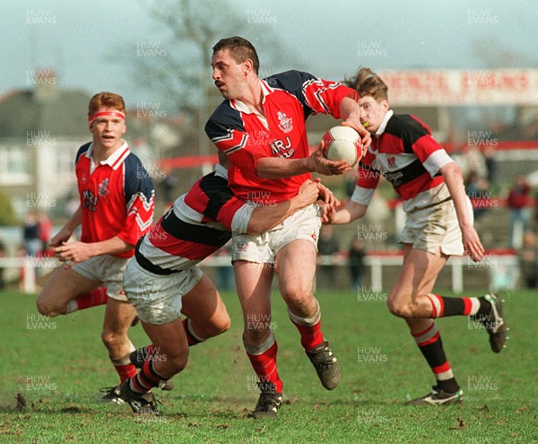 220397 - Llanelli v Pontypool - Paul Morris of Llanelli is tackled by David Lynch