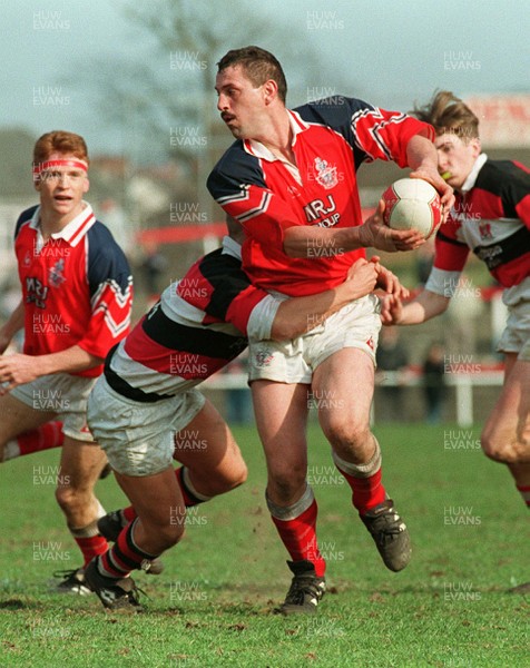 220397 - Llanelli v Pontypool - Paul Morris of Llanelli is tackled by David Lynch