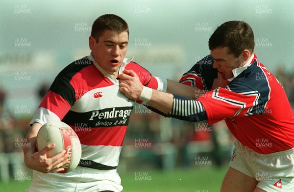 220397 - Llanelli v Pontypool - Lennie Woodard of Pontypool is tackled by Matthew Wintle