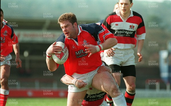 220397 - Llanelli v Pontypool - Andrew Gibbs of Llanelli is tackled by David Bishop