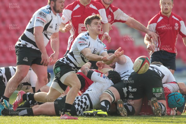 220315 - Llanelli RFC v Pontypridd RFC - Principality Premiership -Joel Raikes spins the ball away from a Pontypridd scrum