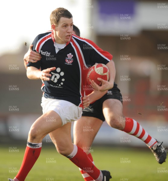 26.01.08 - Llanelli v Pontypridd - Konica Minolta Cup - Llanelli's Darren Simpson is tackled by Gareth McCarthy 