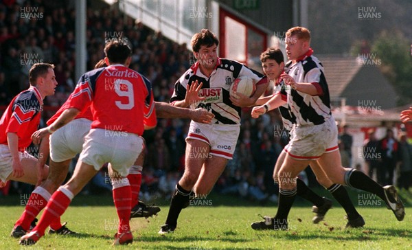 290397 - Llanelli v Pontypridd - Crispin Cormack of Pontypridd is tackled by Mike Voyle