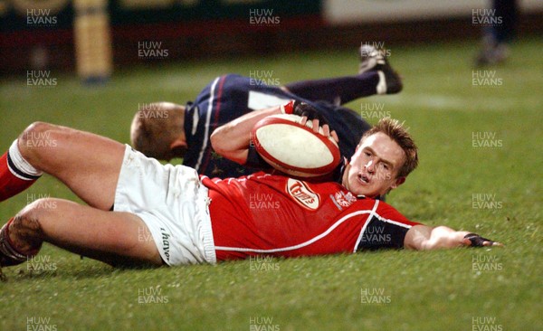 030103 - Llanelli v Swansea - Welsh Premiership - Llanelli's Matthew J Watkins scores third try despite tackle by Shaun Payne