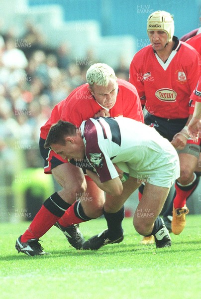 150599 - Llanelli v Swansea - SWALEC Cup Final -  Swansea's Mark Taylor is tackled by Scott Quinnell