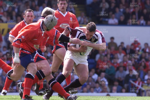 150599 - Llanelli v Swansea - SWALEC Cup Final -  Swansea's Mark Taylor is tackled by Scott Quinnell