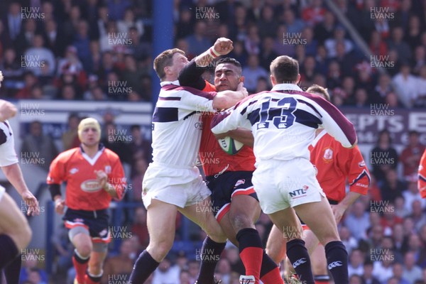 150599 - Llanelli v Swansea - SWALEC Cup Final -  Llanelli's Salesi Finau is tackled by Scott Gibbs and Mark Taylor(13)