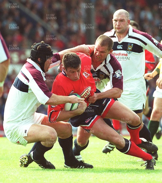 150599 - Llanelli v Swansea - SWALEC Cup Final -  Llanelli's Mike Voyle is caught by the Swansea defence 