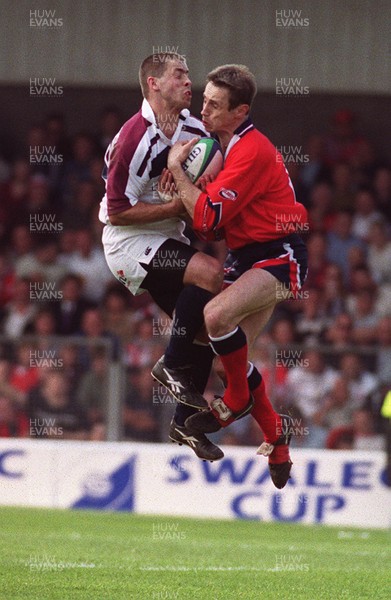 150599 - Llanelli v Swansea - SWALEC Cup Final -  Llanelli's  Wayne Proctor and Swansea's David Weatherley contest a high ball