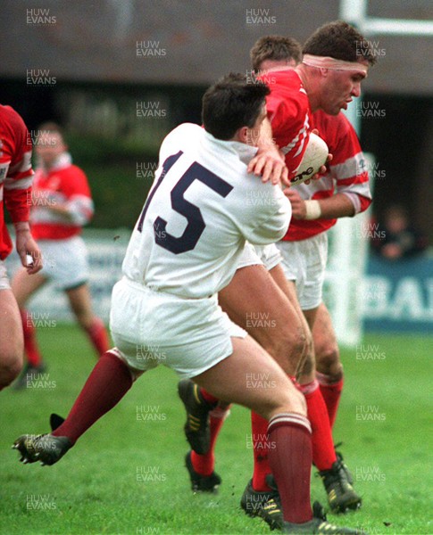 240493 - Llanelli 29 - 18 Swansea - SWALEC Cup Semi Final -  Llanelli's Mark Perego is tackled by Anthony Clement 