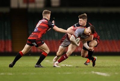 070424 - Llaneilli Wanderers v Glynneath - Division One Cup Final - Lewis Jones of Llanelli Wanderers is tackled by Sam Harris and Aled Evans of Glynneath 