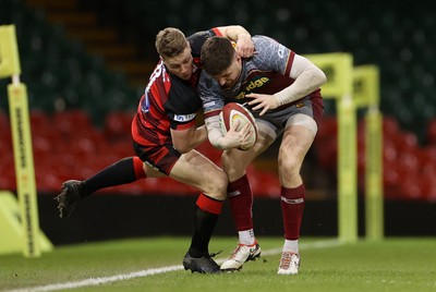 070424 - Llaneilli Wanderers v Glynneath - Division One Cup Final - Lewis Jones of Llanelli Wanderers is tackled by Aled Evans of Glynneath 