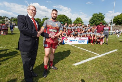 100525 - Llanelli Wanderers v Gorseinon - Admiral Championship West - WRU representative Chris Jones presents the trophy to Llanelli Wanderers captain Rhodri Owens
