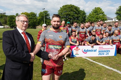 100525 - Llanelli Wanderers v Gorseinon - Admiral Championship West - WRU representative Chris Jones presents the trophy to Llanelli Wanderers captain Rhodri Owens