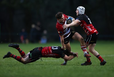 061225 - Llangennech v Brecon - WRU Premiership - Huw Jones of Brecon is tackled by Wil Thomas of Llangennech 