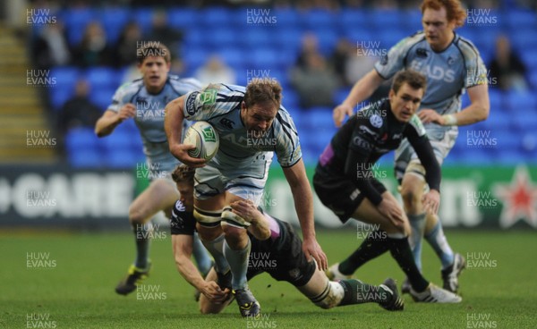 14.01.12 - London Irish v Cardiff Blues - Heineken Cup - Xavier Rush of Cardiff Blues is tackled by Jonathan Spratt of London Irish. 