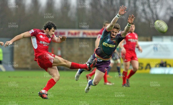 030213 London Welsh v Dragons - LV= Cup - Hallam Amos of Dragons charges down a kick by Ryan Davis of London Welsh 