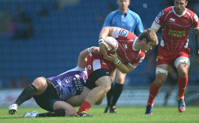 230813 - London Welsh v Scarlets - Preseason Friendly -Rhodri Jones of Scarlets is tackled by Cai Griffiths of London Welsh