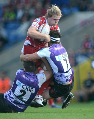 230813 - London Welsh v Scarlets - Preseason Friendly -Dan Thomas of Scarlets is tackled by Nathan Morris and Mike Denbee of London Welsh